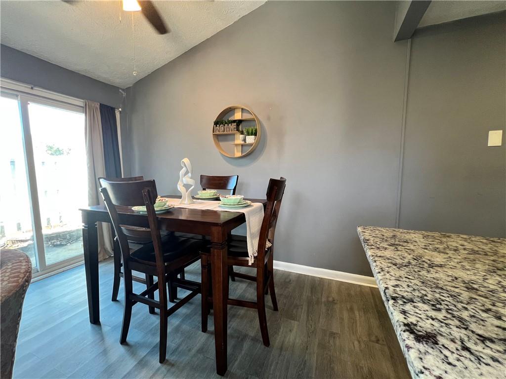 1496 Pine Log Road Northeast, Unit A Conyers, GA 30012 - Photo 17 of 24 a view of a dining room with furniture window and wooden floor