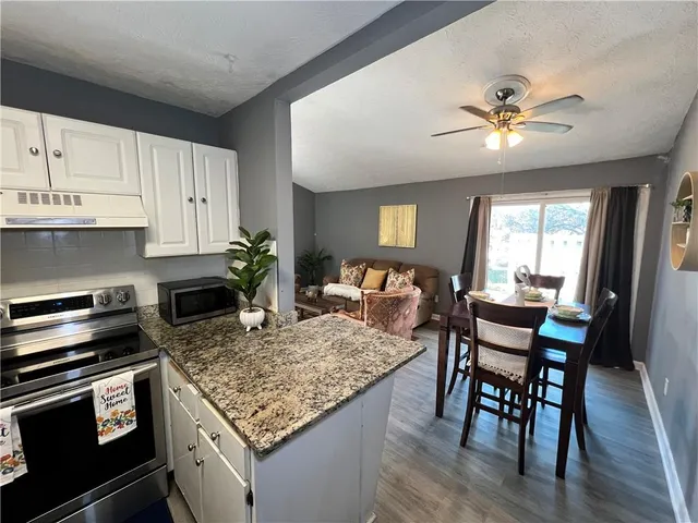 a kitchen with a table chairs and microwave