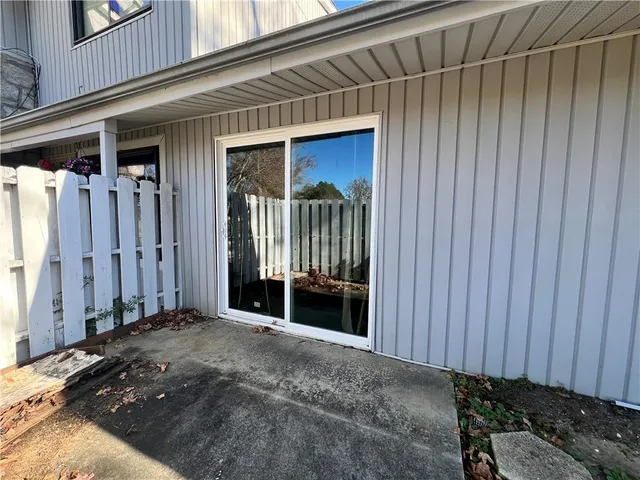 a view of a front door and a car garage