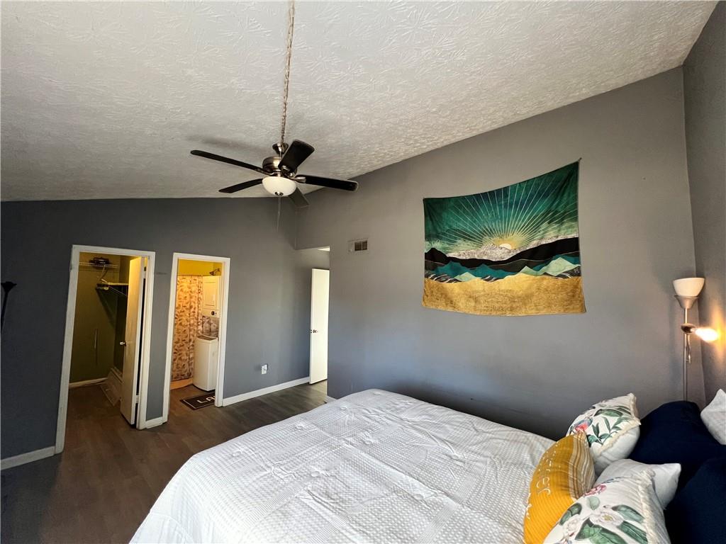 1496 Pine Log Road Northeast, Unit A Conyers, GA 30012 - Photo 10 of 24 a bedroom with a bed and a painting on the wall