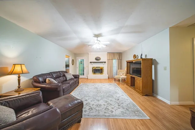 a living room with furniture and a wooden floor