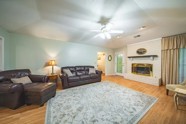 a living room with furniture and a fireplace