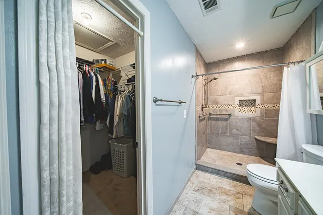 a bathroom with a shower and toilet
