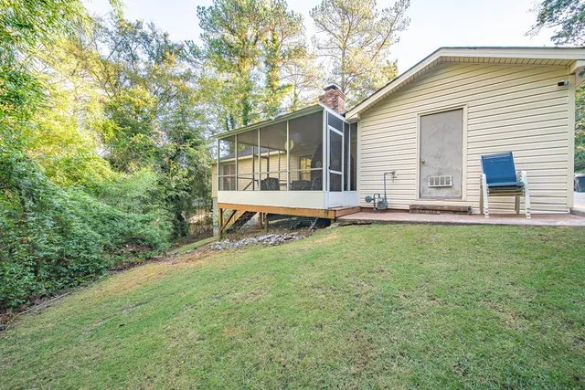 a backyard of a house with table and chairs