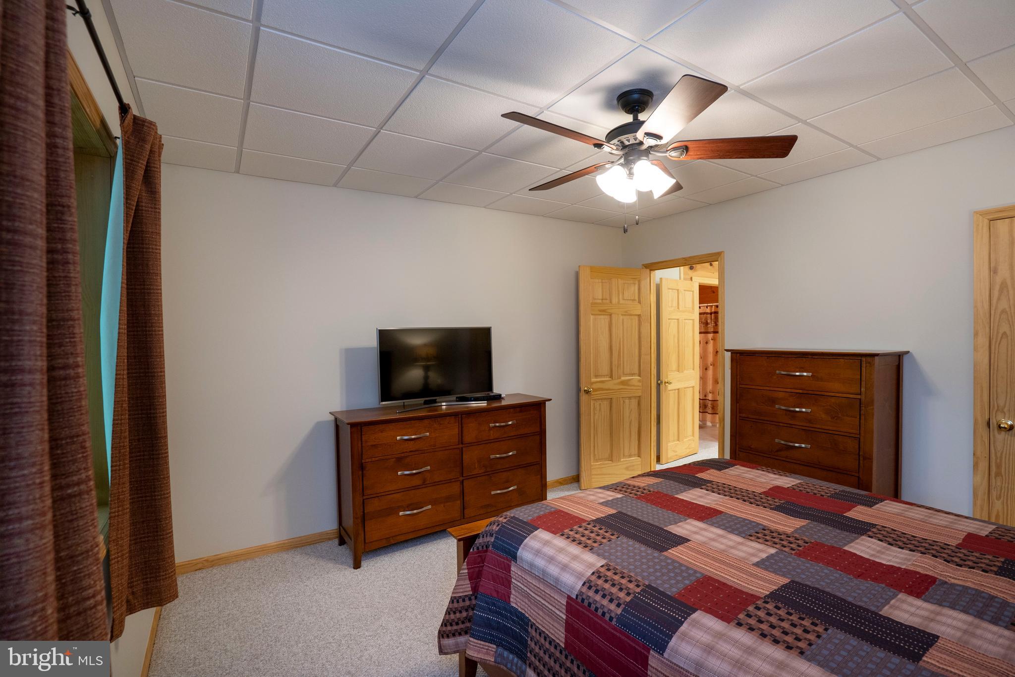 1400 Jacks Mountain Road McVeytown, PA 17051 - Photo 101 of 129 a bedroom with a bed and a flat screen tv