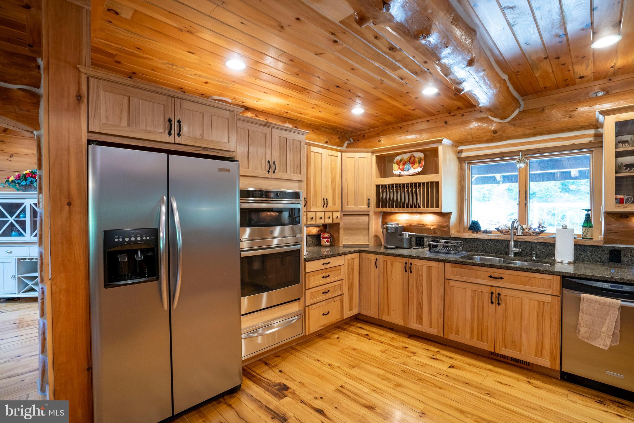 1400 Jacks Mountain Road McVeytown, PA 17051 - Photo 40 of 129 a kitchen with granite countertop a refrigerator and wooden cabinets
