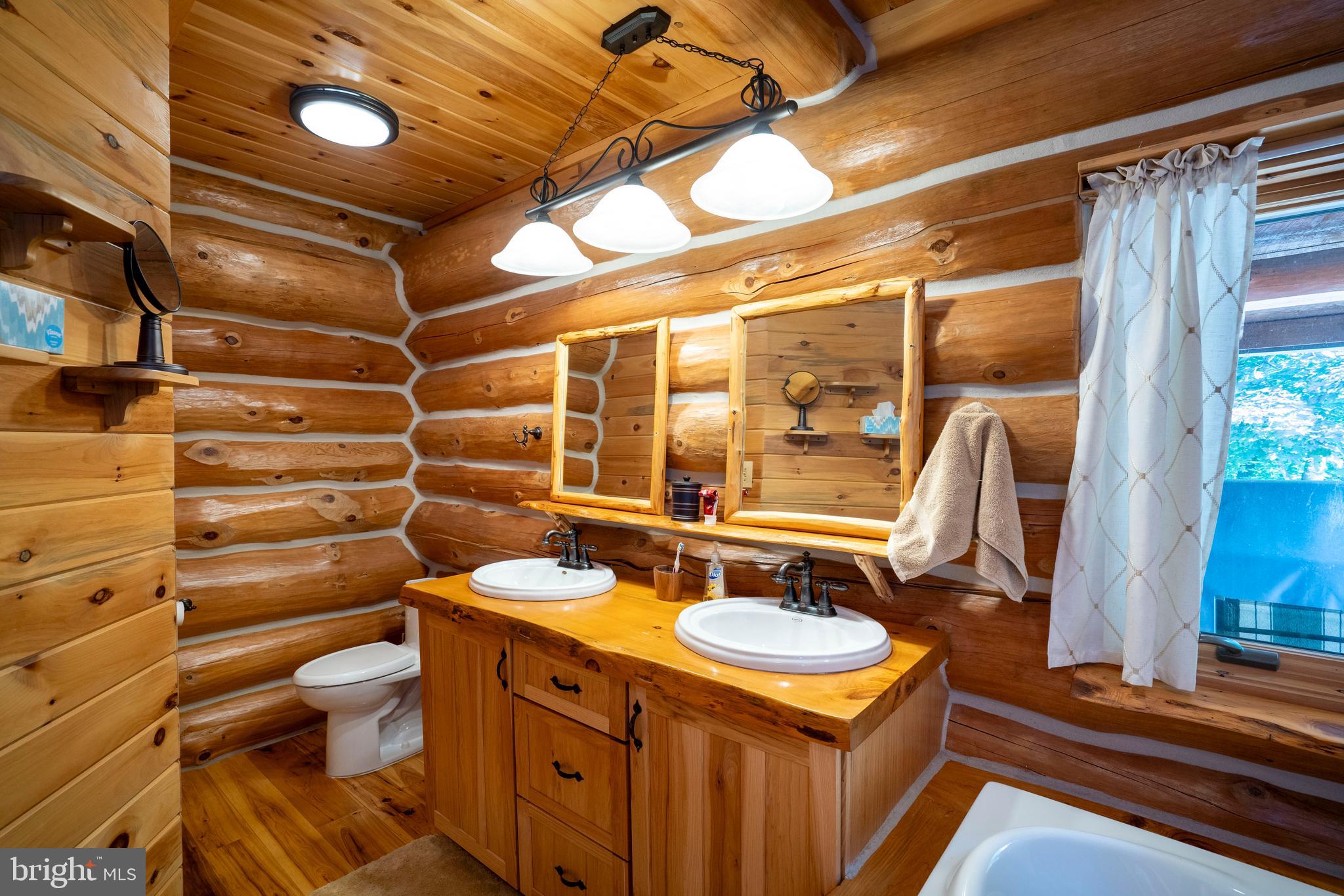 1400 Jacks Mountain Road McVeytown, PA 17051 - Photo 64 of 129 a bathroom with a sink mirror vanity and toilet