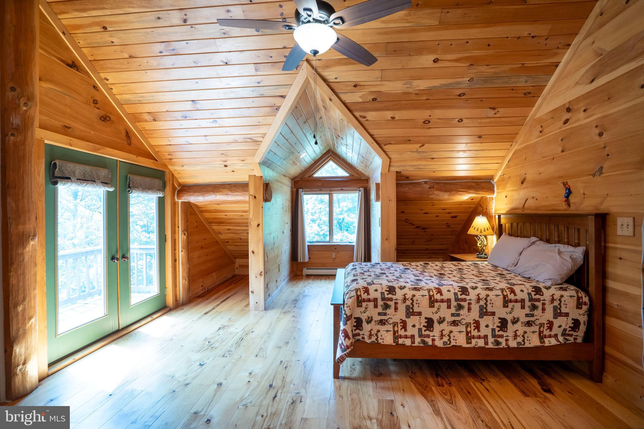 1400 Jacks Mountain Road McVeytown, PA 17051 - Photo 74 of 129 a bedroom with a bed and wooden floor