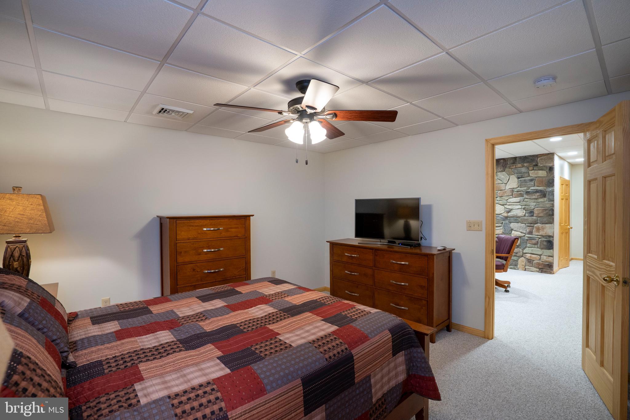 1400 Jacks Mountain Road McVeytown, PA 17051 - Photo 96 of 129 a bedroom with a bed and a chandelier