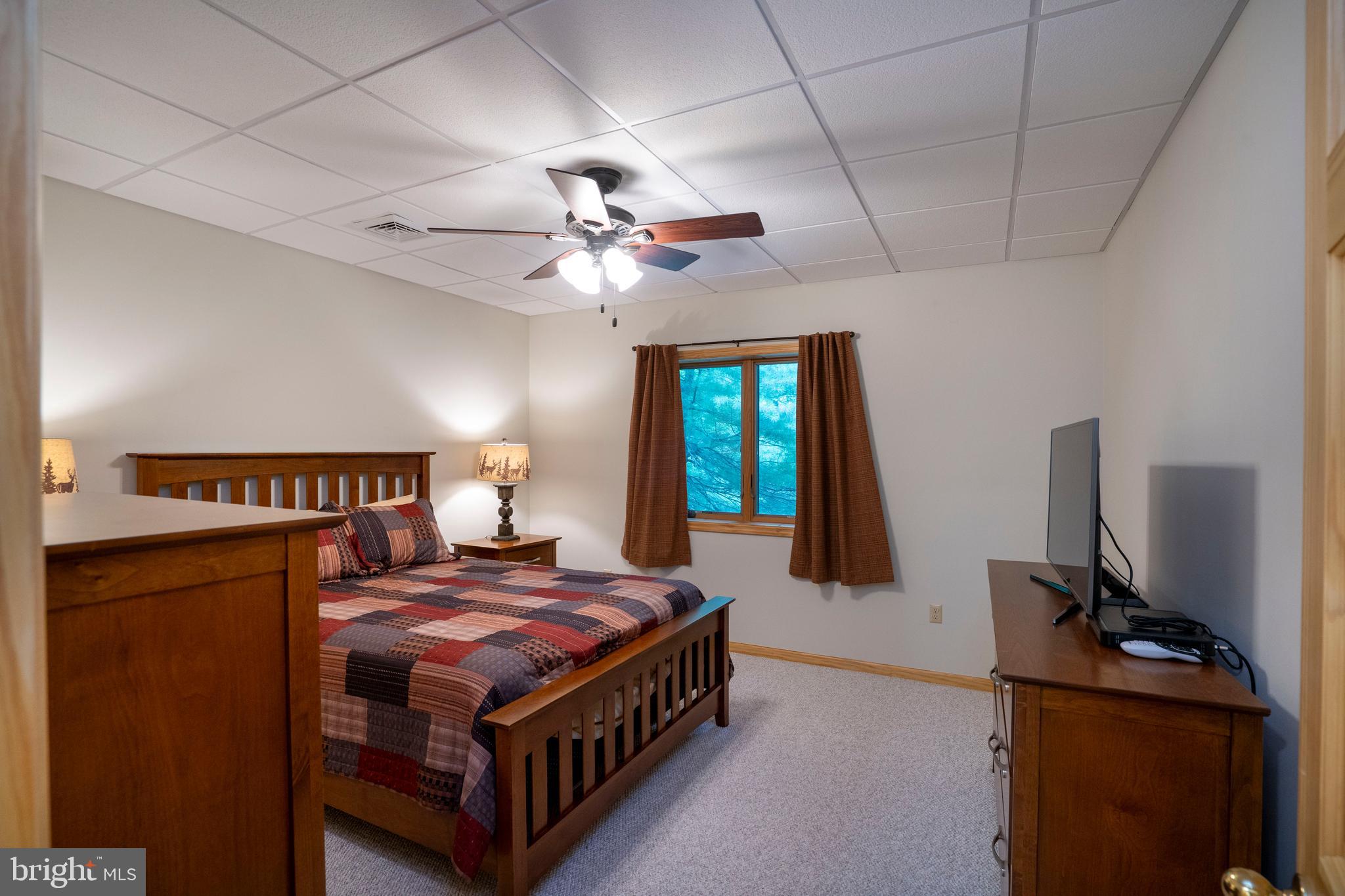 1400 Jacks Mountain Road McVeytown, PA 17051 - Photo 99 of 129 a bed room with a bed and a flat screen tv