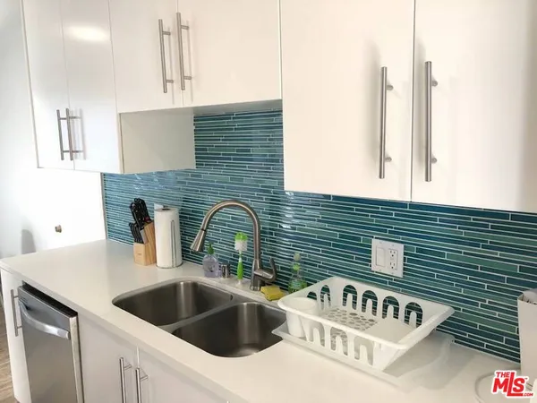 a kitchen with a sink and cabinets