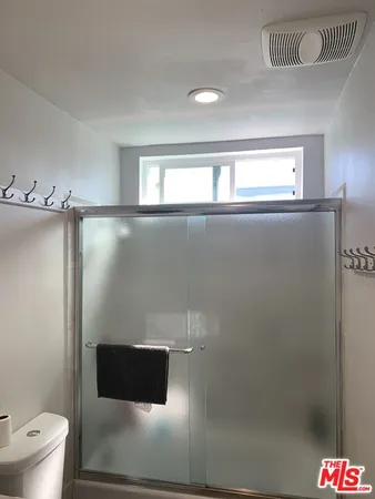 a bathroom with a toilet and a shower