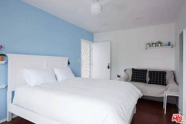 a bedroom with a bed and a desk