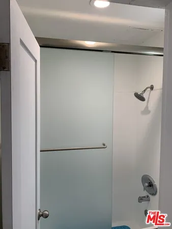 a bedroom with a bed and a television