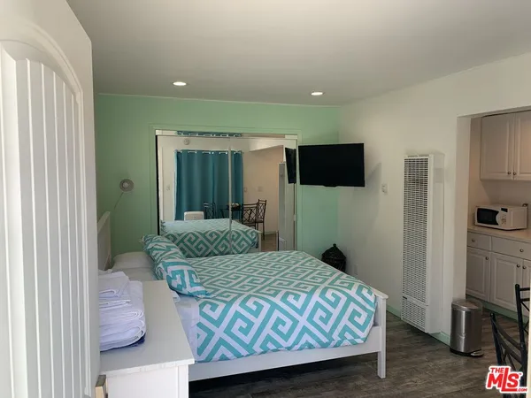 a bedroom with a bed and a television in it