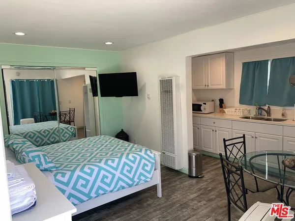a kitchen with a white table and chairs in it