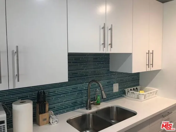 a kitchen with a sink and cabinets