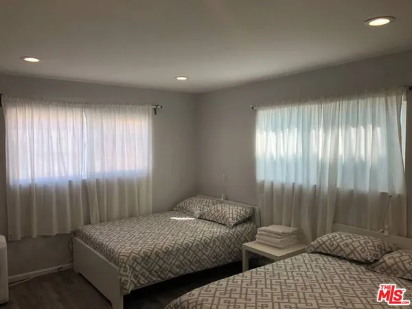a bedroom with two beds and painted walls