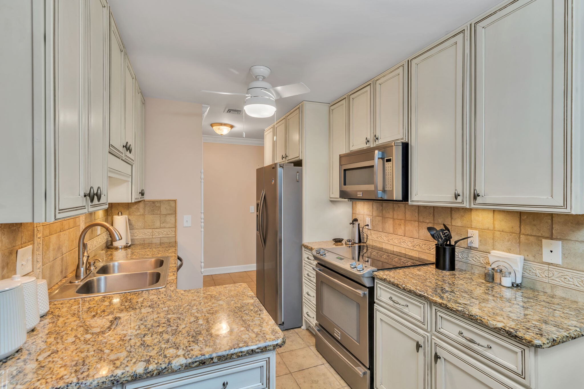 1035 General George Patton Road Nashville, TN 37221 - Photo 8 of 32 a kitchen with stainless steel appliances granite countertop a sink stove and refrigerator