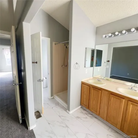 a spacious bathroom with a granite countertop sink mirror and vanity