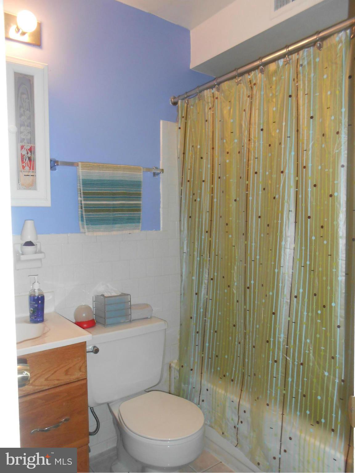 11917 Tarragon Road, Unit I Reisterstown, MD 21136 - Photo 7 of 9 a bathroom with a toilet a sink and a shower