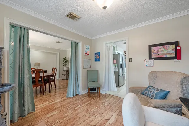 a living room with furniture and a dining table with kitchen view