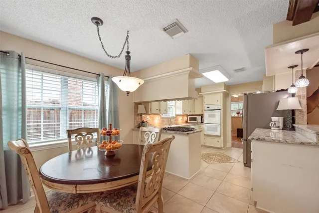 a dining room filled counter top space and a chandelier