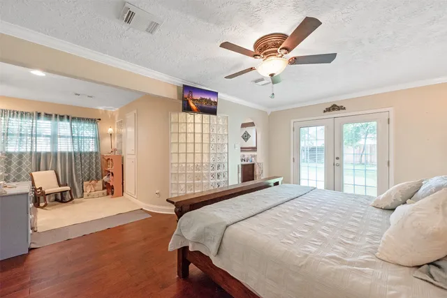 a bedroom with a bed and wooden floor