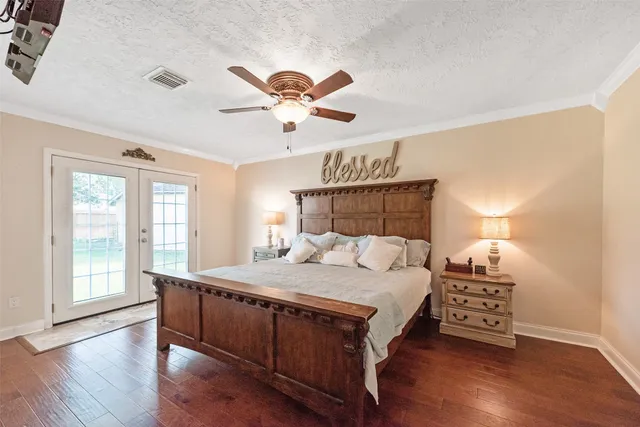 a bedroom with a large bed and a window