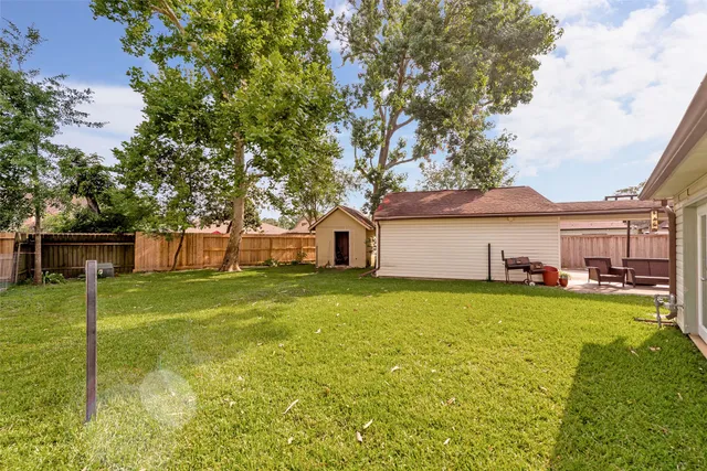 a front view of a house with a garden and yard