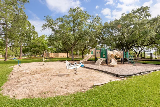 a view of a patio with a table and chairs under an umbrella