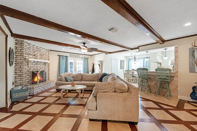 a living room with furniture a fireplace and a table