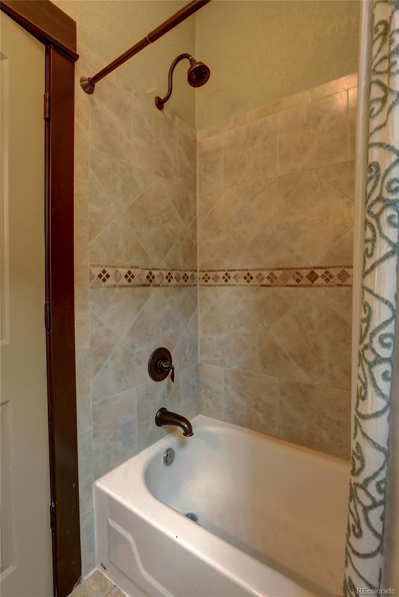 424 Inca Street Denver, CO 80204 - Photo 8 of 20 a bathroom with a shower and a bath tub