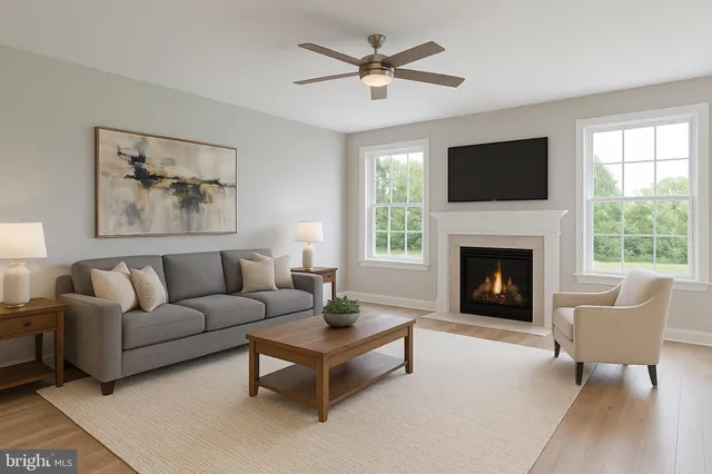 a living room with furniture a window and a fireplace