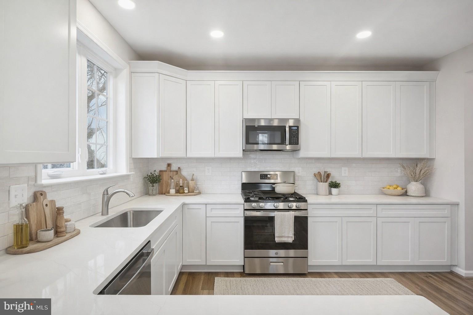 Hamilton York Road Parkton, MD 21120 - Photo 6 of 13 a kitchen with stainless steel appliances granite countertop a sink a stove a microwave a counter space and cabinets