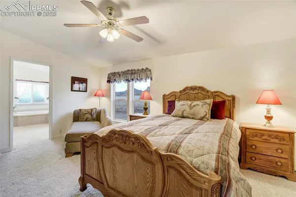 a bedroom with a bed and ceiling fan