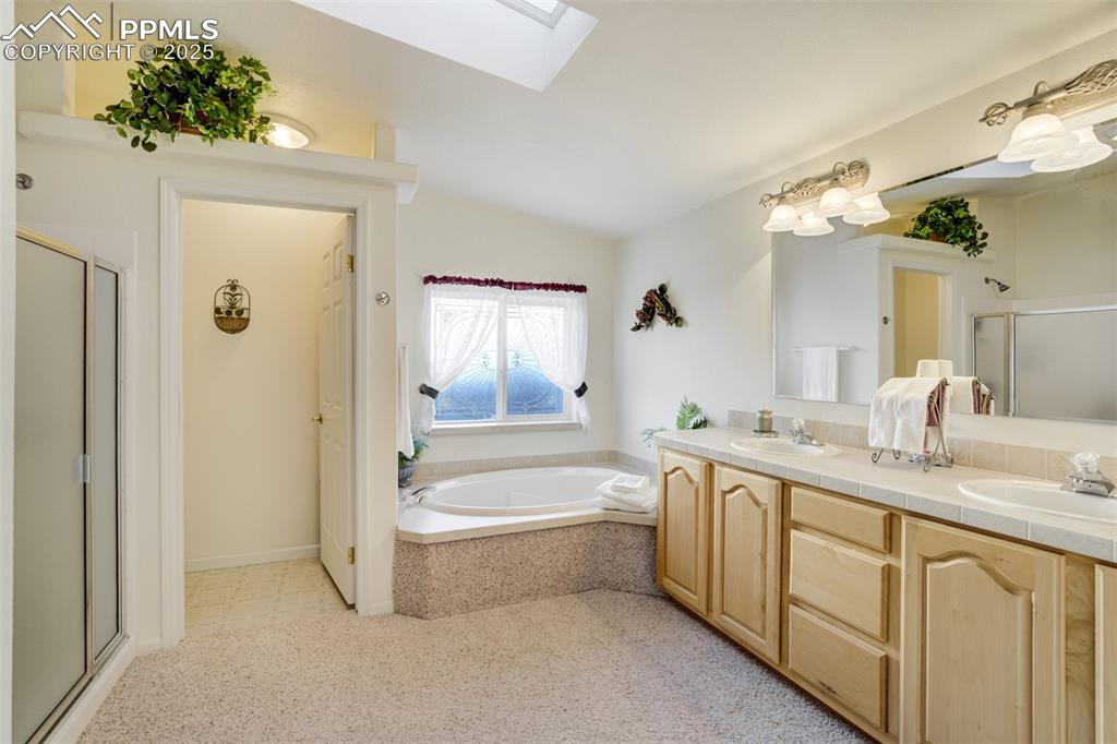 688 Tiara Road Lake George, CO 80827 - Photo 17 of 46 a bathroom with a tub sink and mirror
