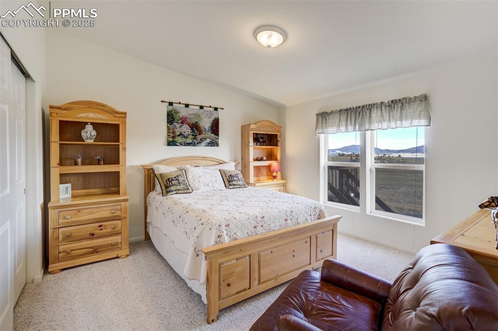 688 Tiara Road Lake George, CO 80827 - Photo 20 of 46 a bedroom with a bed and a dresser next to a window