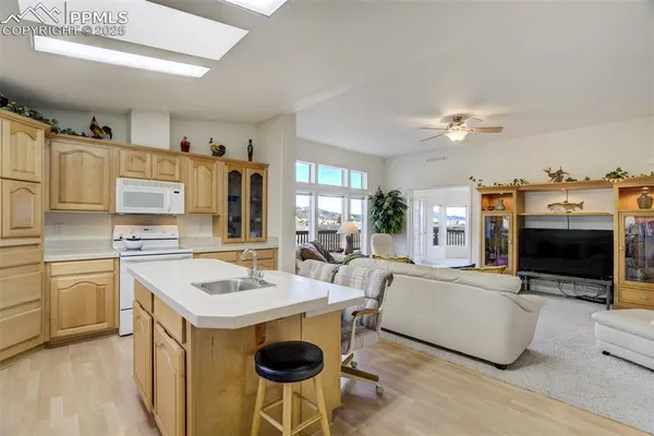 a kitchen with stainless steel appliances a stove a sink and a refrigerator
