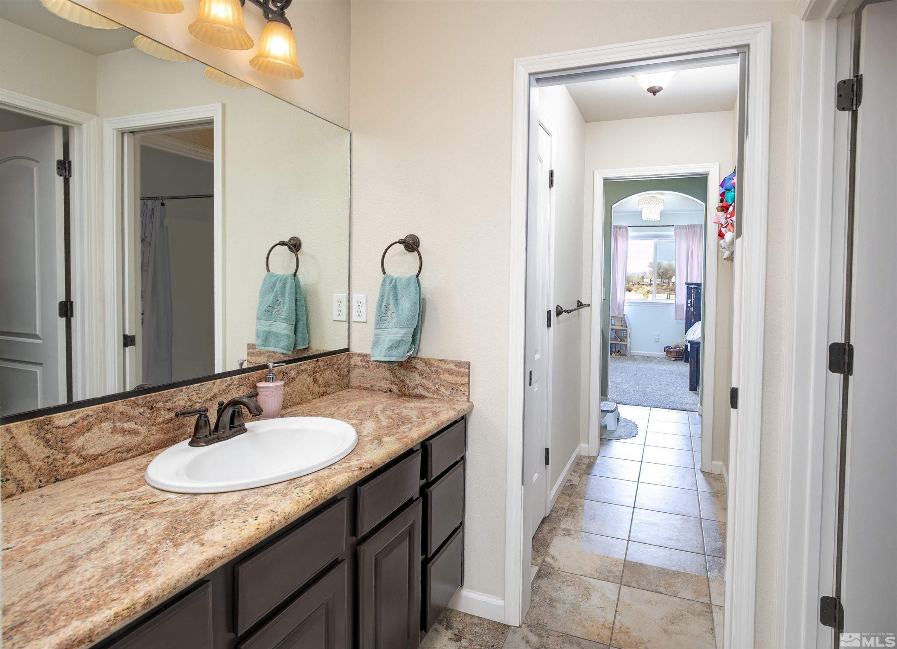 1675 Sky Ridge Drive Fallon, NV 89406 - Photo 15 of 31 a en suite bathroom with a granite countertop sink and a mirror