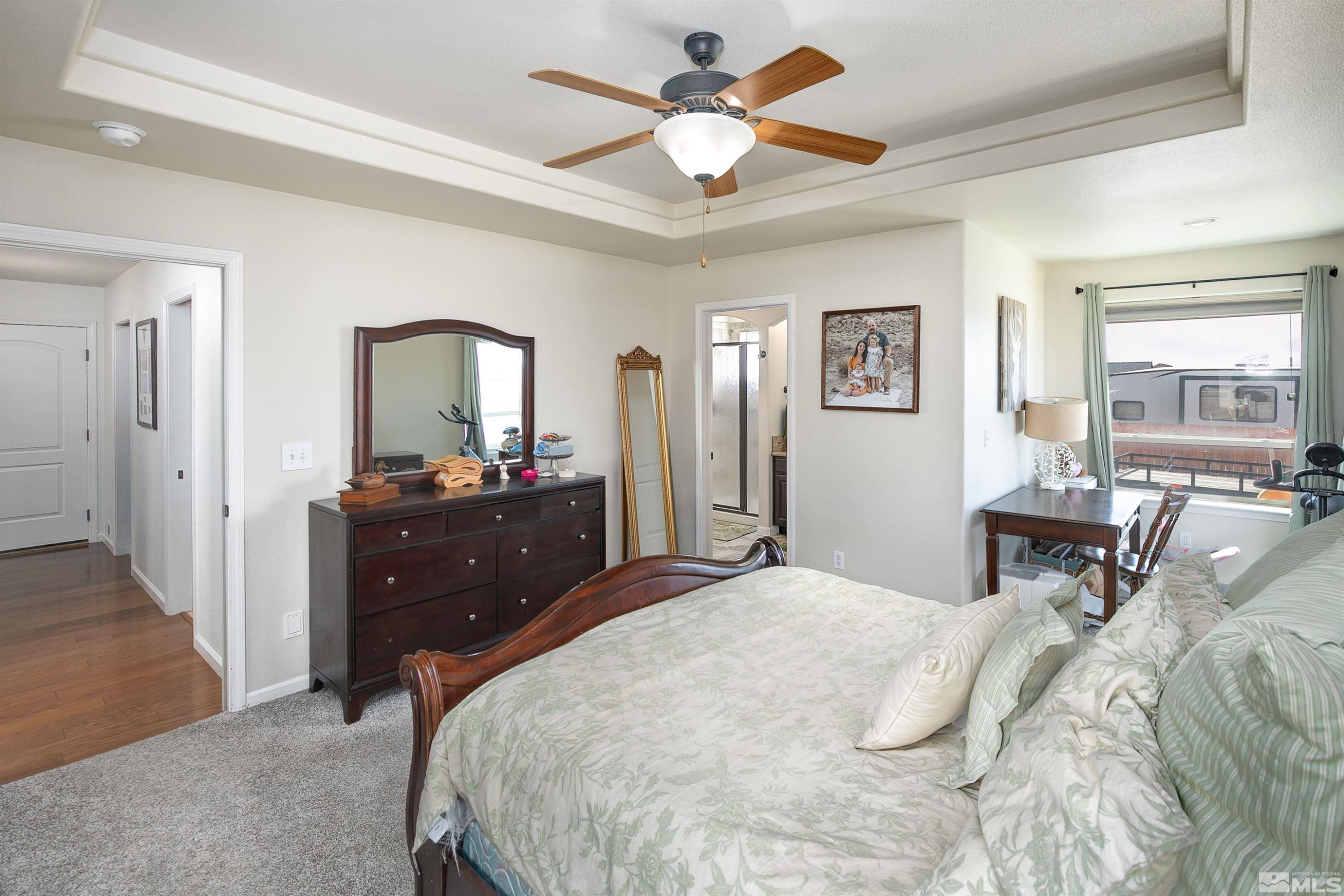 1675 Sky Ridge Drive Fallon, NV 89406 - Photo 16 of 31 a bedroom with a bed a table and dresser