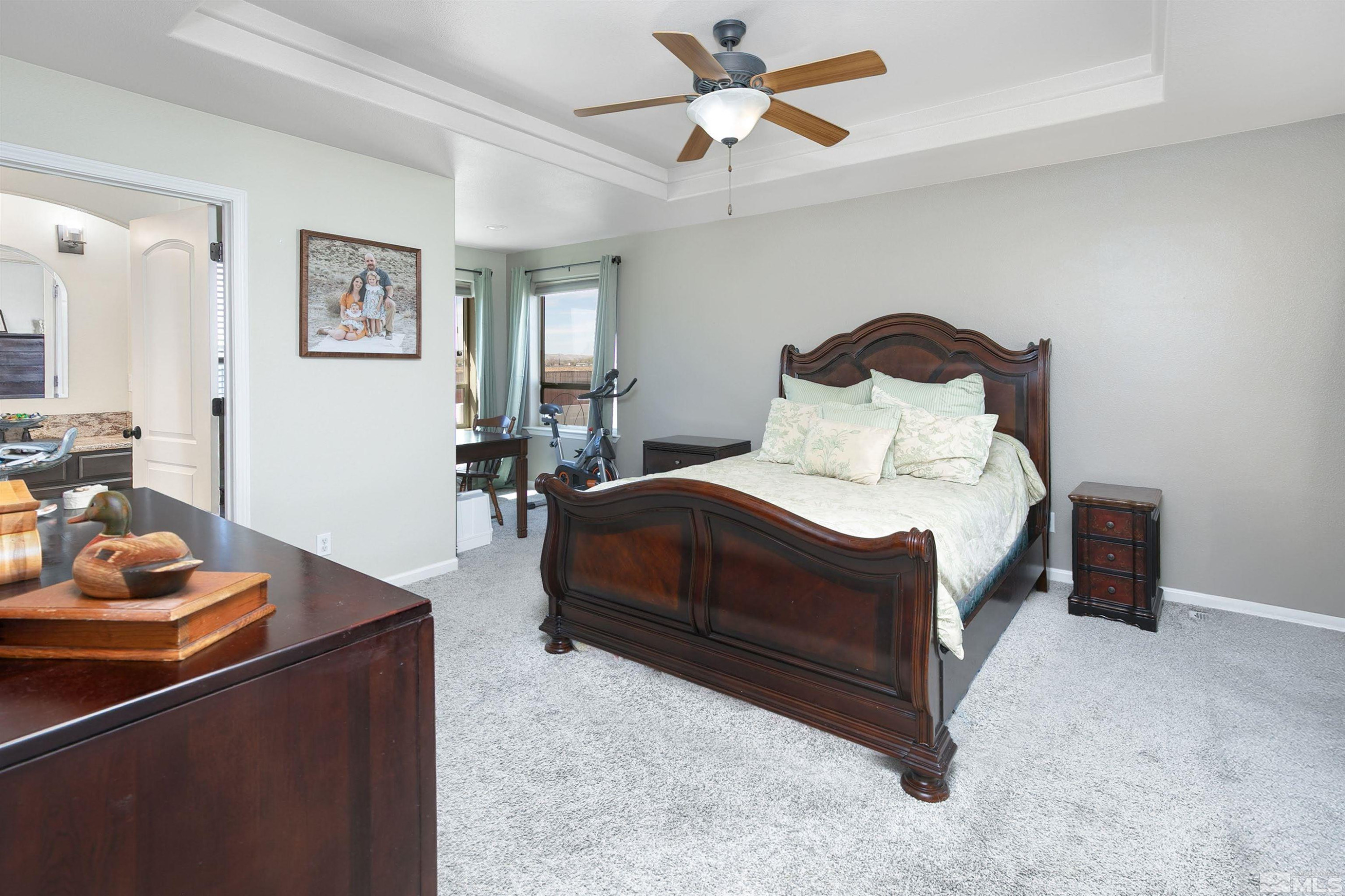 1675 Sky Ridge Drive Fallon, NV 89406 - Photo 17 of 31 a bedroom with a bed and a chandelier