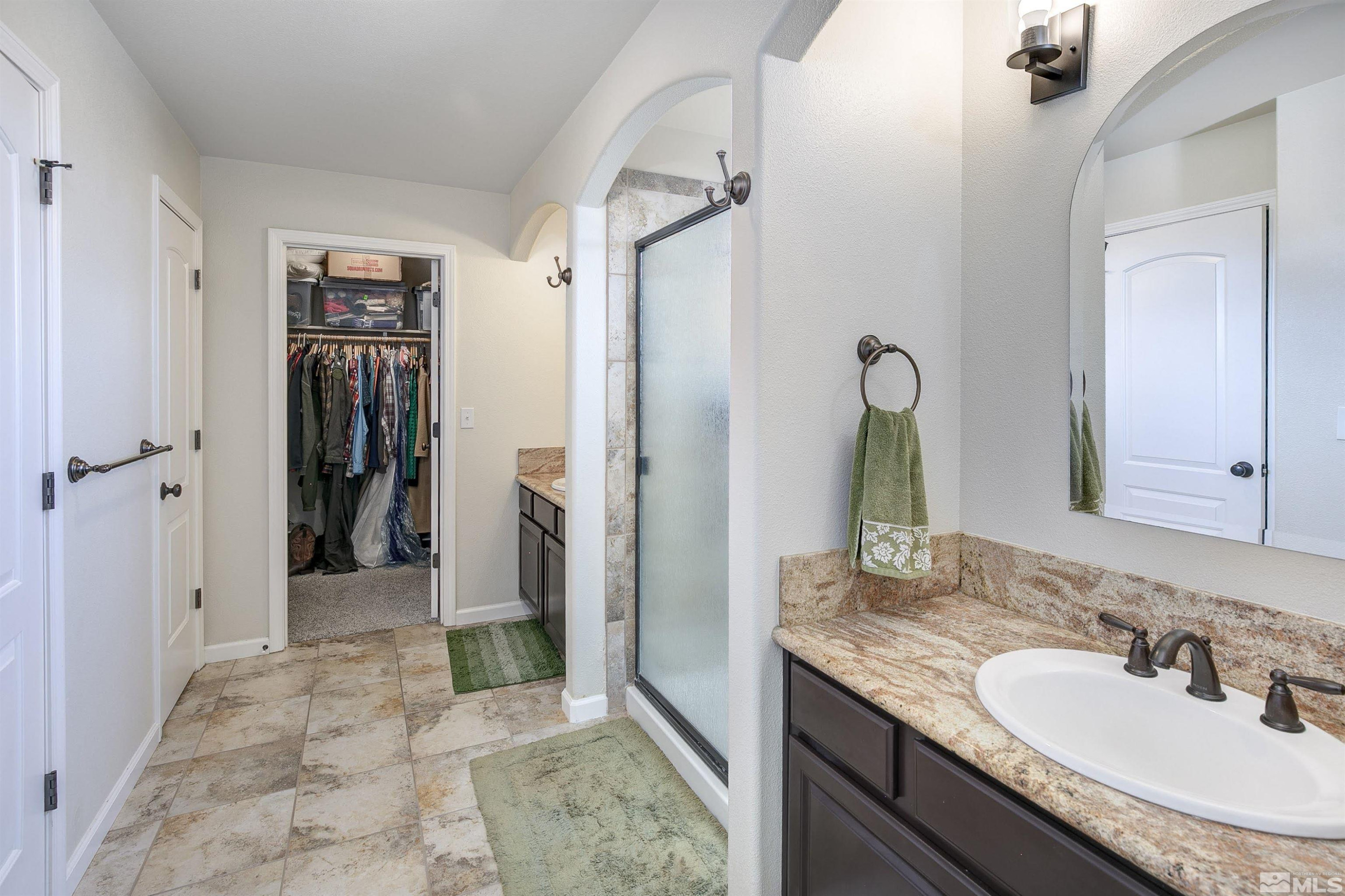 1675 Sky Ridge Drive Fallon, NV 89406 - Photo 18 of 31 a bathroom with a granite countertop sink and a mirror