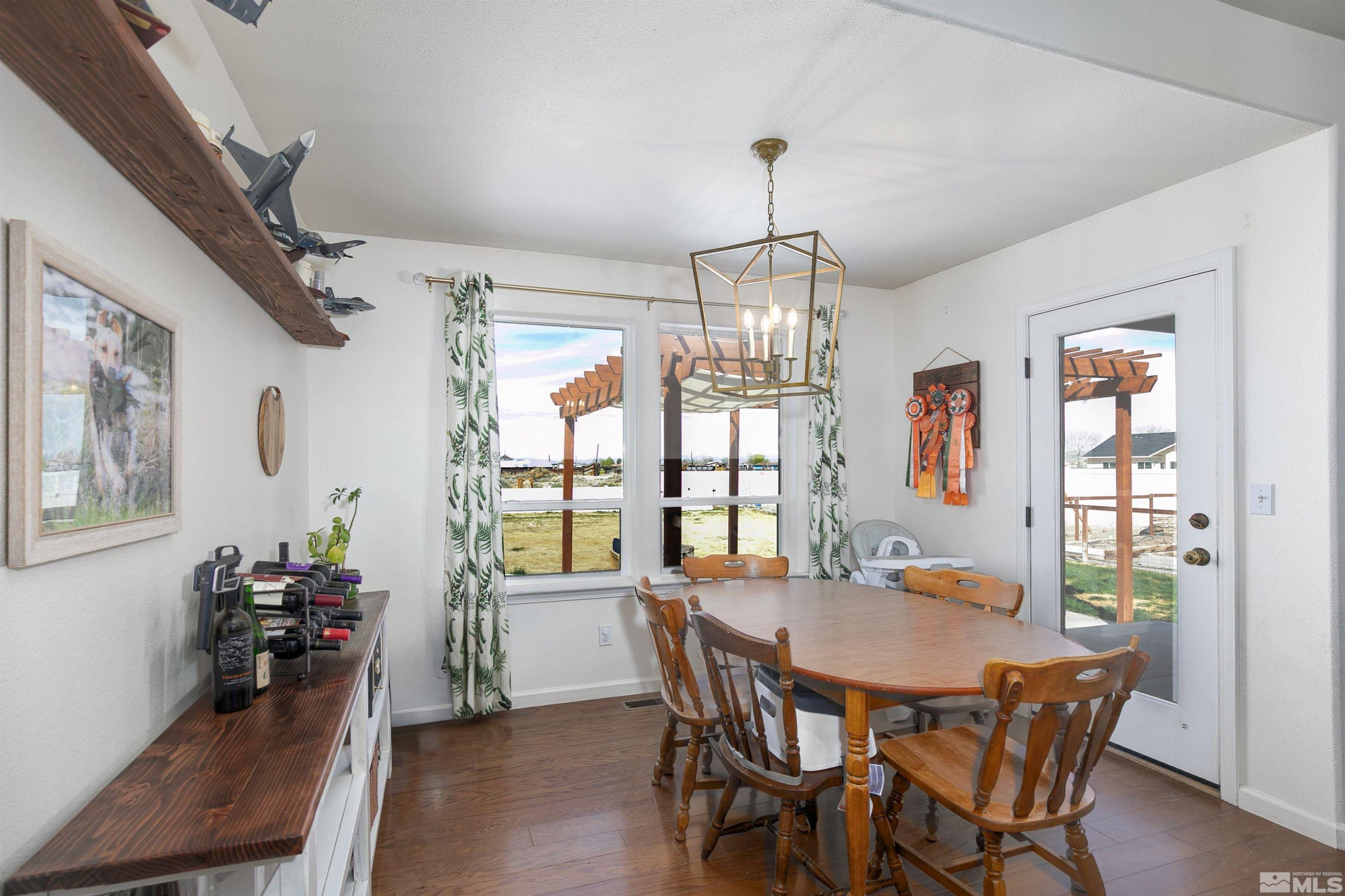 1675 Sky Ridge Drive Fallon, NV 89406 - Photo 9 of 31 a view of a dining room with furniture window and wooden floor