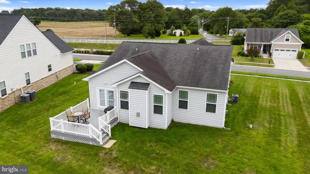 a aerial view of a house with a yard table and chairs