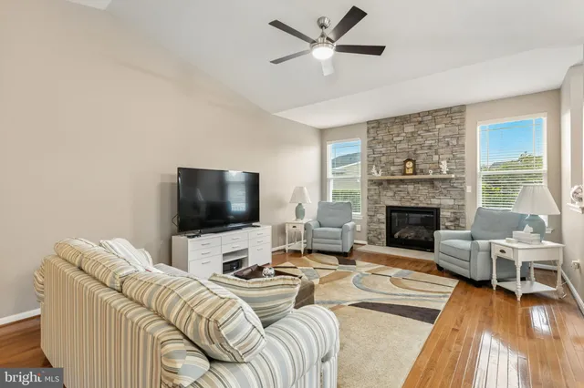 a kitchen with granite countertop stainless steel appliances a refrigerator stove top oven and sink