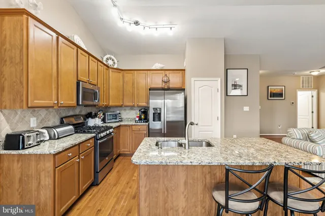 a bedroom with a bed and a lamp on the dresser