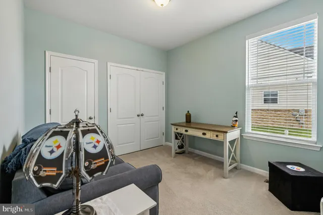 a bedroom with a large bed and a flat screen tv