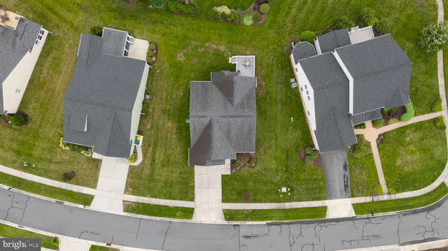 an aerial view of a house with garden space and street view