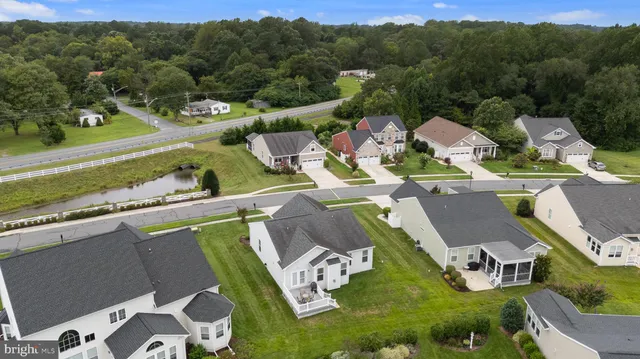 a view of a house with pool and chairs